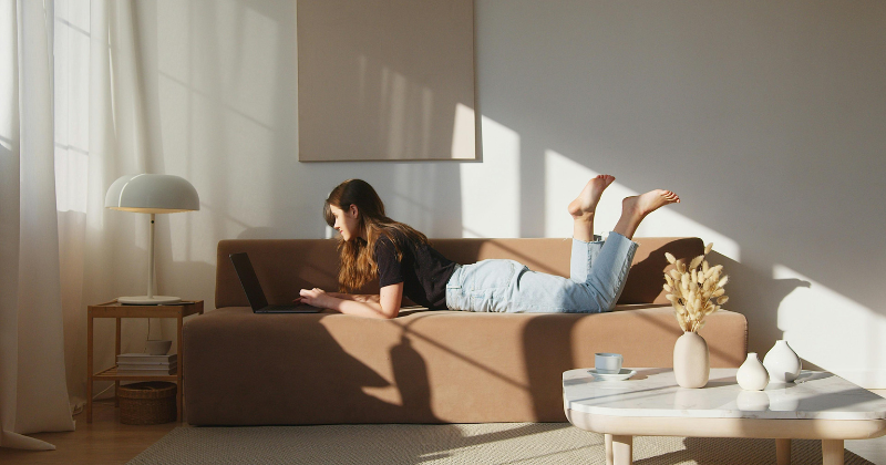 A woman relaxes on a perfect, affordable sofa.